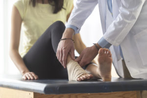Doctor treating a sprained ankle