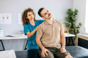 emale orthopedist examining patient's back