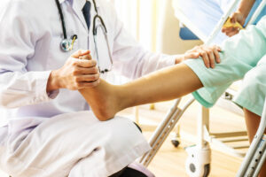 Orthoepdic Doctor examining patient leg injury in orthopedic clinic