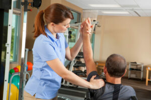 Physical Therapist Evaluating Range Of Motion during shoulder seaparation rehabilitation